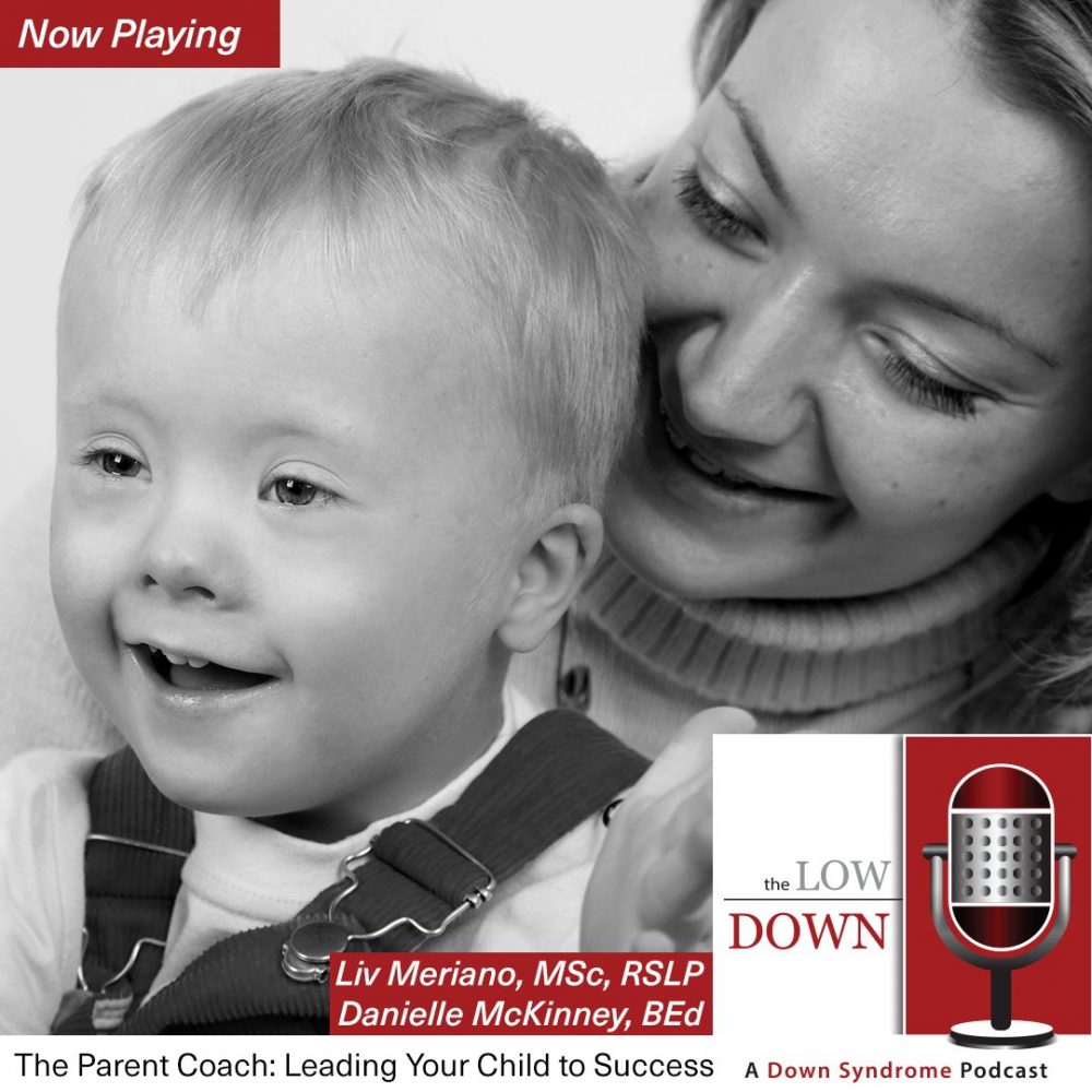 Boy with Down syndrome clapping on mom's lap