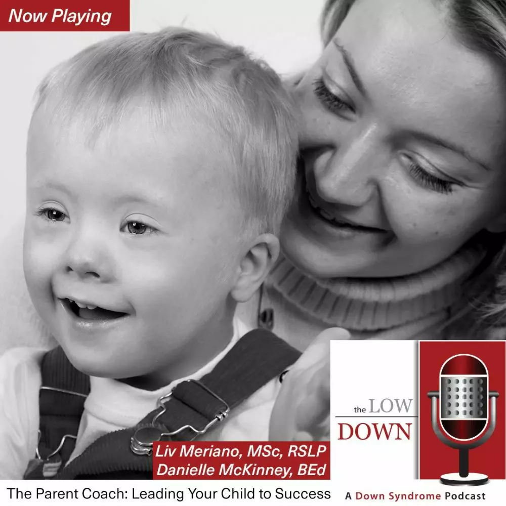 Boy with Down syndrome clapping on mom's lap