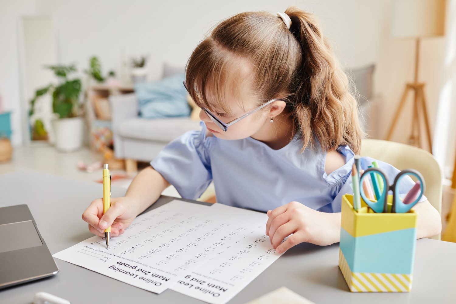 Girl with Down syndrome works on math quiz