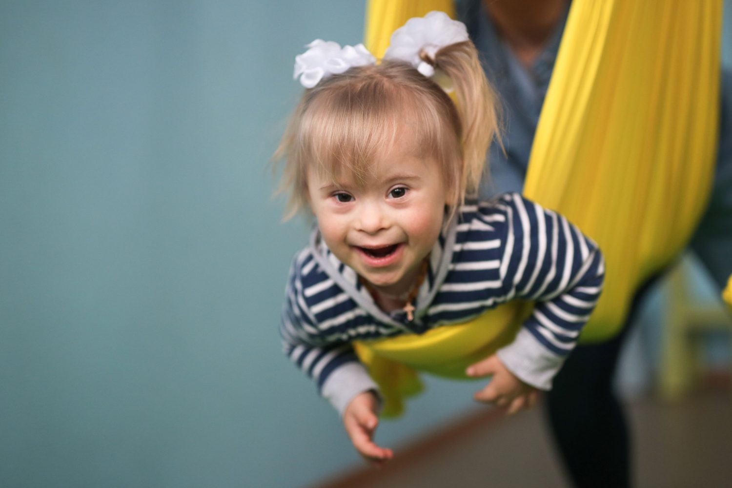 Girl with Down syndrome swings in hammock