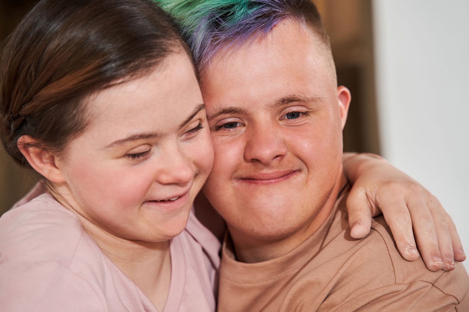 Couple with Down syndrome embraces