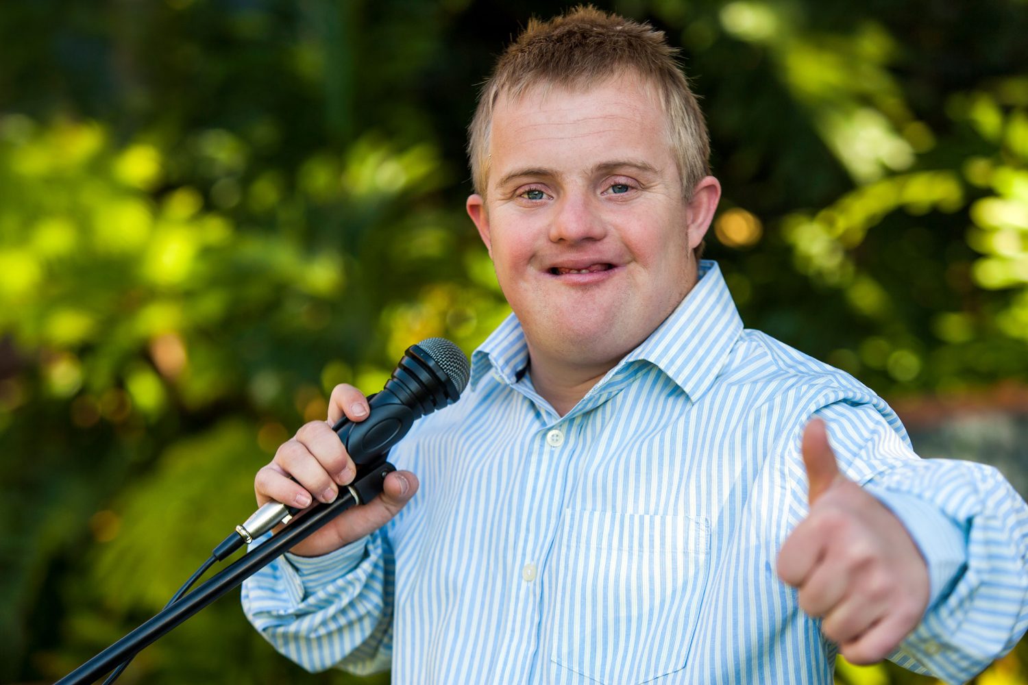Man with Down syndrome sings with microphone