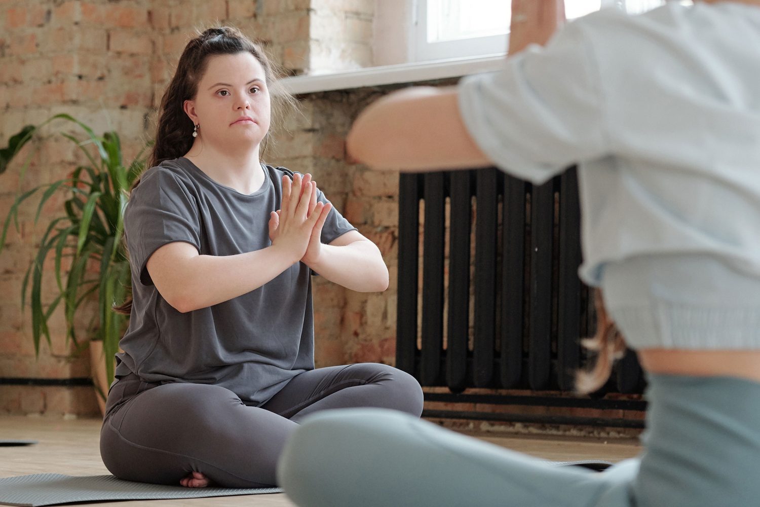 Young woman with Down syndrome does yoga