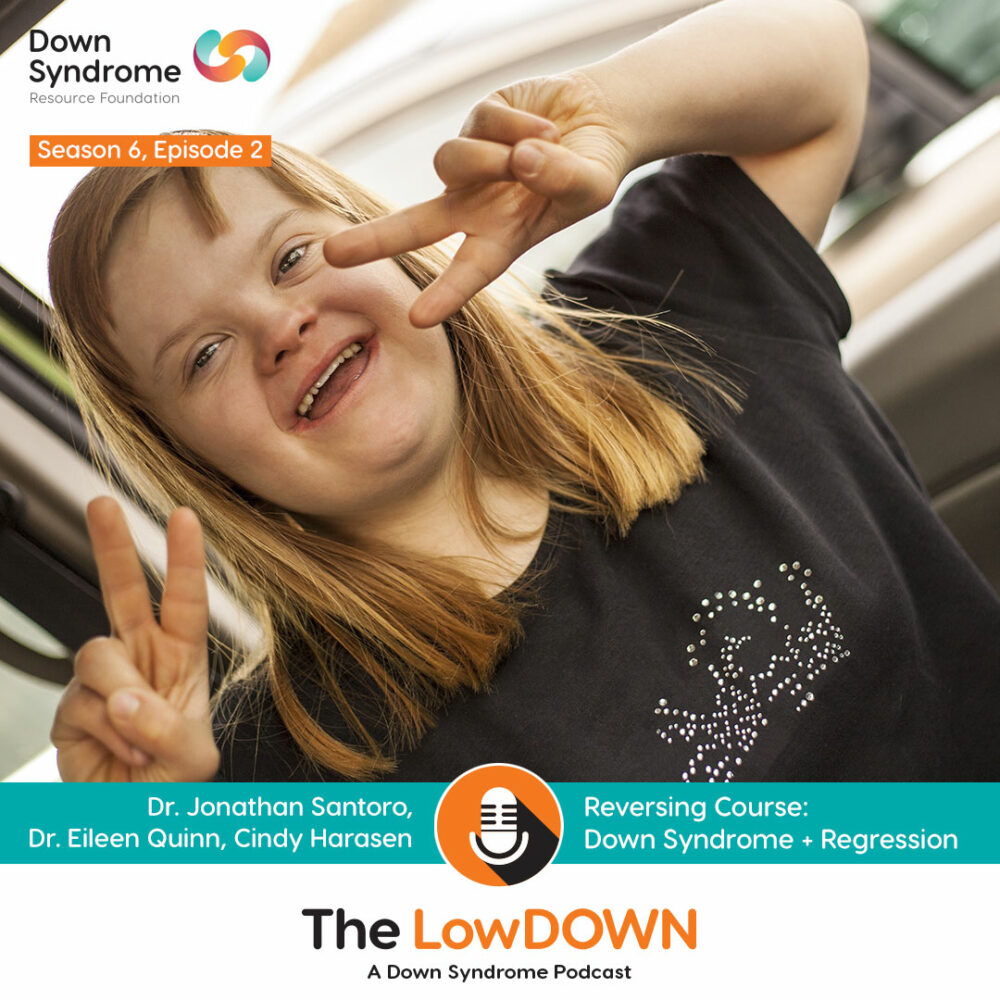 Blonde haired woman with Down syndrome flashing peace signs, sitting in a car