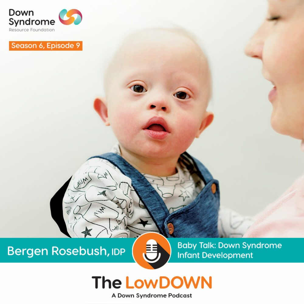 white baby with Down syndrome being held by his mom
