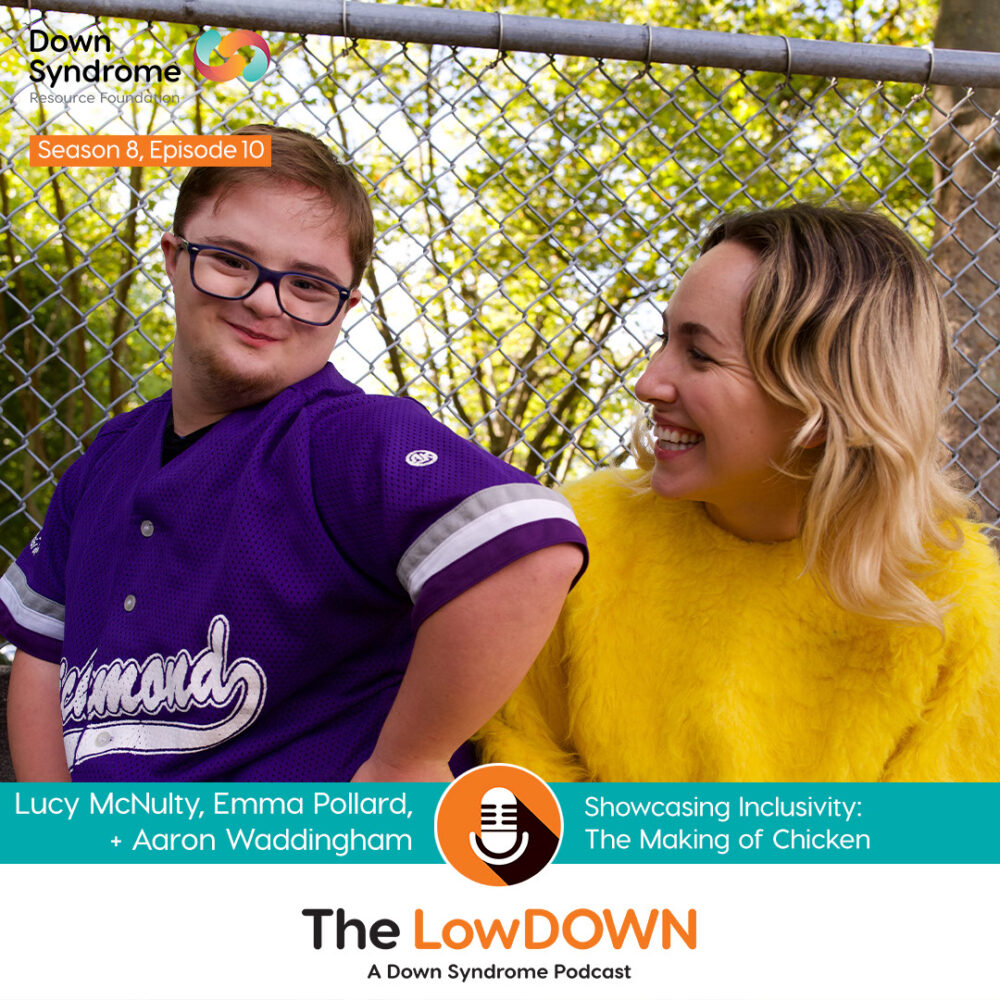 young white man with Down syndrome wearing purple baseball jersey poses with blonde woman wearing a chicken costume