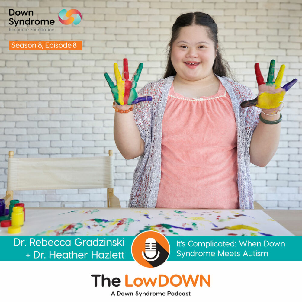 teenage female asian with Down syndrome holds up hands, which have different colours of paint all over them