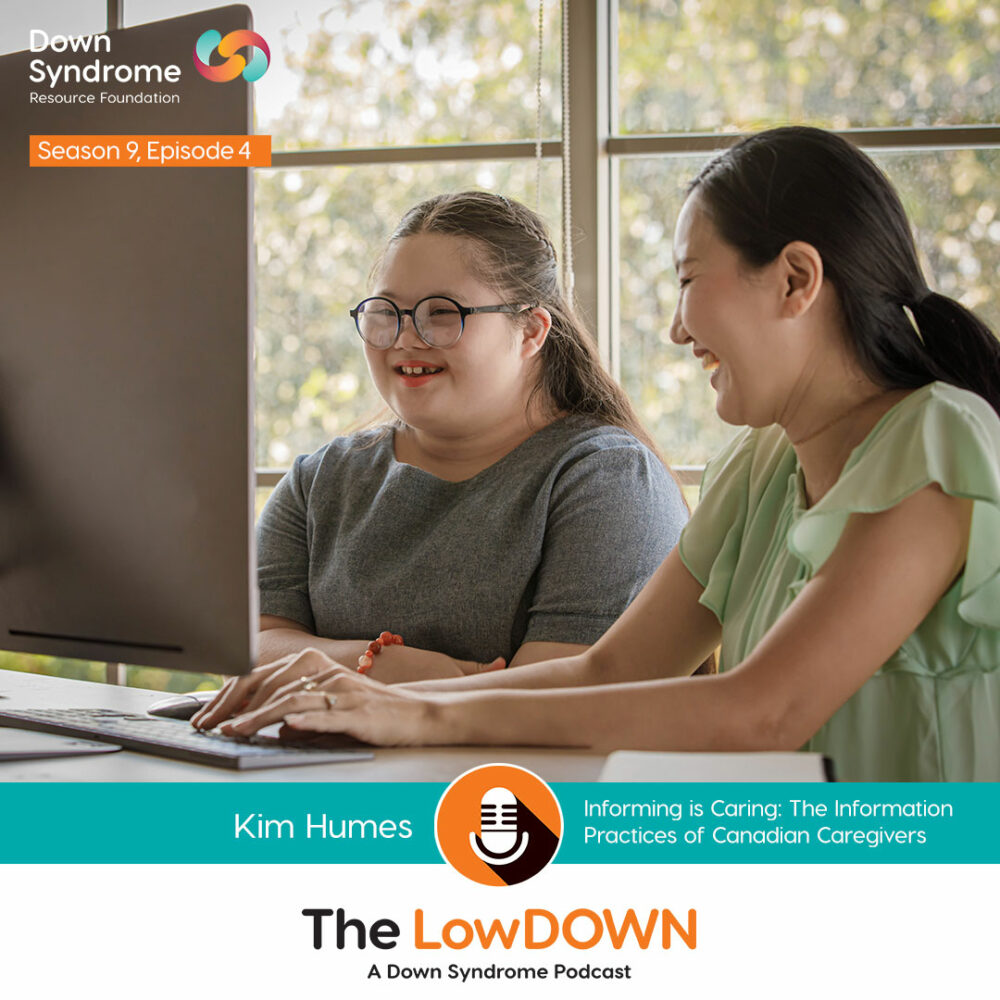 young Asian woman with Down syndrome looks at computer monitor with her mom sitting beside her