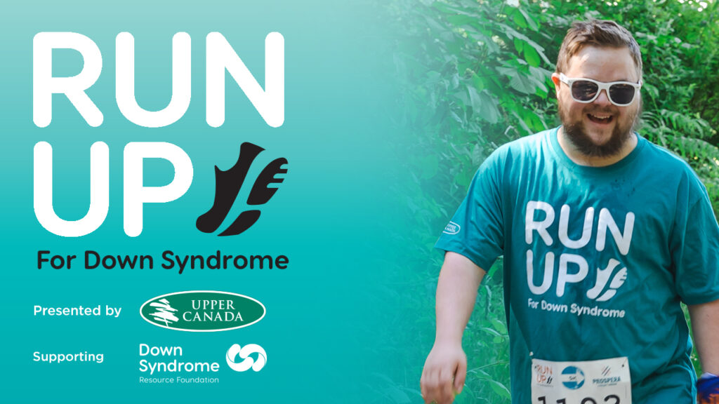 young white man with Down syndrome wearing turquoise Run Up for Down Syndrome t-shirt and white sunglasses, with Run Up for DS logo, and logos for presenting sponsor Upper Canada Forest Products and beneficiary organization the Down Syndrome Resource Foundation